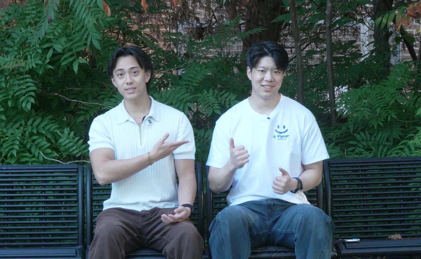 Ethan and his EAP Media co-founder Peter Zhang on a bench, filming