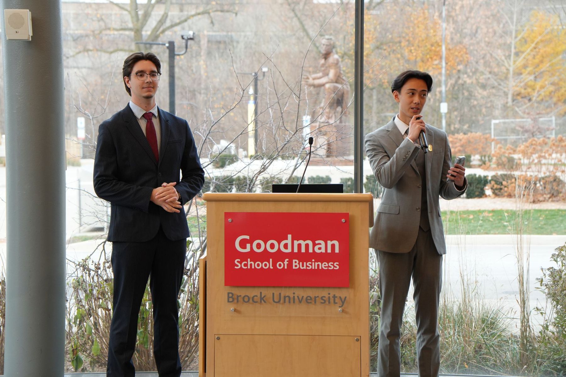 Ethan Chiang and Ivan Litviakov at the Goodman School of Business podium